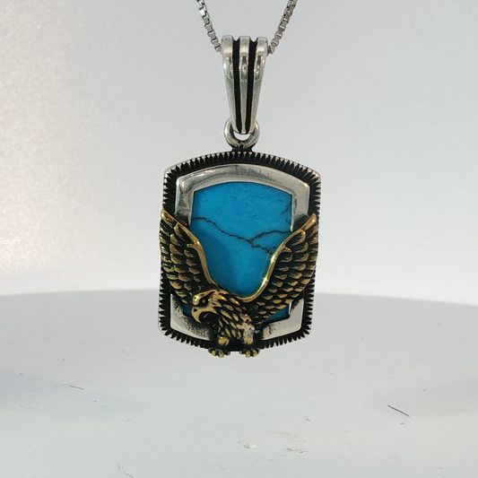 Silver Pendant Featuring Emerald Cut Blue Turquoise Gemstone with Plated Yellow Gold Eagle Design