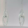 Load and play video in Gallery viewer, Sterling Silver Triple Oval Dangle Earrings with Spherical Accent

