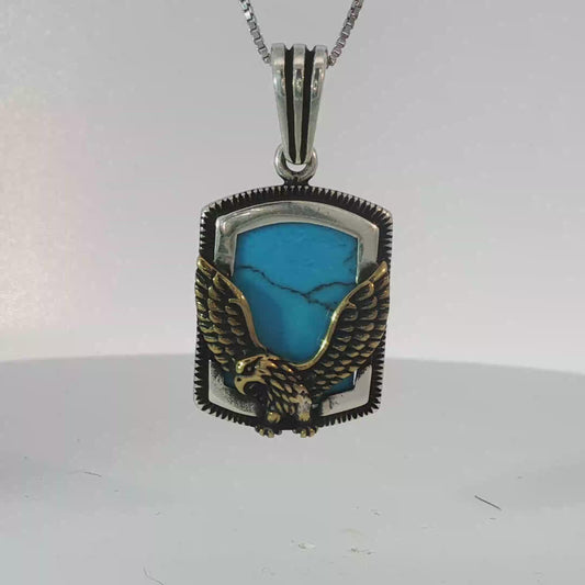 Silver Pendant Featuring Emerald Cut Blue Turquoise Gemstone with Plated Yellow Gold Eagle Design