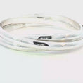 Load and play video in Gallery viewer, Tiffany & Co Silver Trinity Bangle
